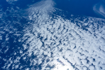 Blue sky background with white clouds.