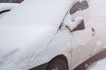 The car in the snow. Winter weather concept. Cold and frosty concept. Windows in ice.
