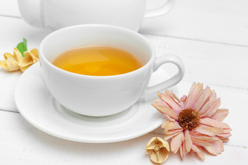teapot and cups of tea on a white wooden background