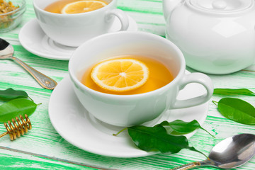 Black tea on green wooden background