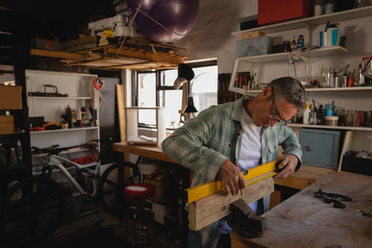 Mature carpenter working in workshop