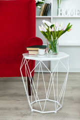 Beautiful cozy inline living room. Home entertainment. A table with a vase and flowers