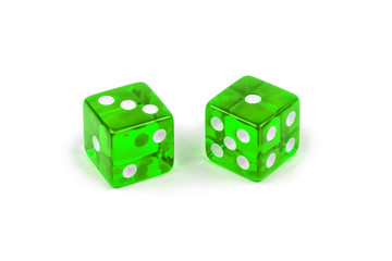 Two green glass dice isolated on white background. Three and one with a shadow.