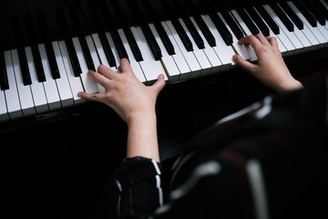 Beautiful asian girl learn to play piano.