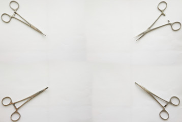 cramp forceps on corner of white copy space