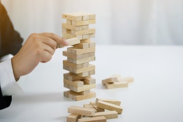 .Planning risk and strategy in businessman gambling placing wooden block.Business concept for growth success proces