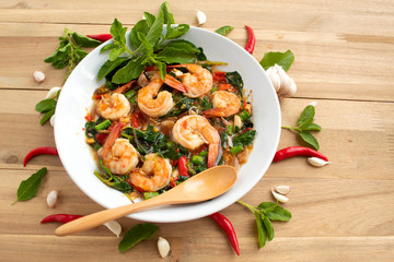 Stir fried shrimp basil with red chilli and garlic on wood