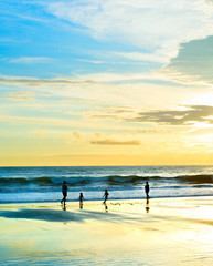 Family walking sunset beach Bali