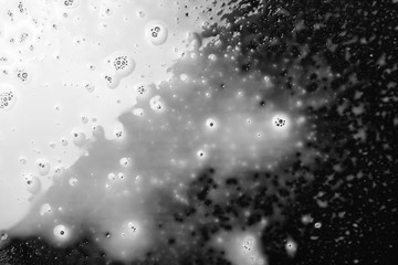 Spilled milk puddle isolated on black background and texture with clipping path, top view
