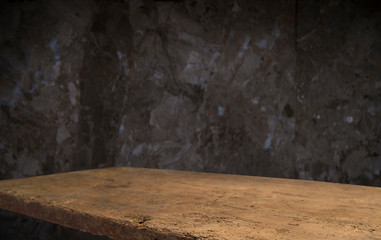 Old wooden table with brick background dark