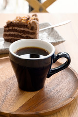 Hot coffee and toffee cake on a wooden table