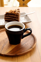 Hot coffee and toffee cake on a wooden table