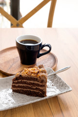 Hot coffee and toffee cake on a wooden table