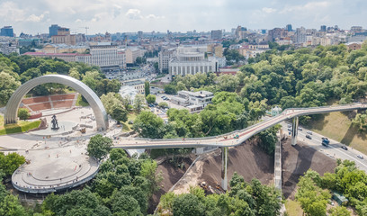 Aerial drone view of new pedestrian cycling park bridge construction, hills, parks and Kyiv...
