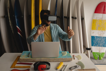 Man using virtual reality headset in a workshop