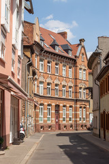 Fototapeta na wymiar Quiet narrow street with a beautiful brick house in the central part of Erfurt city, Germany. 