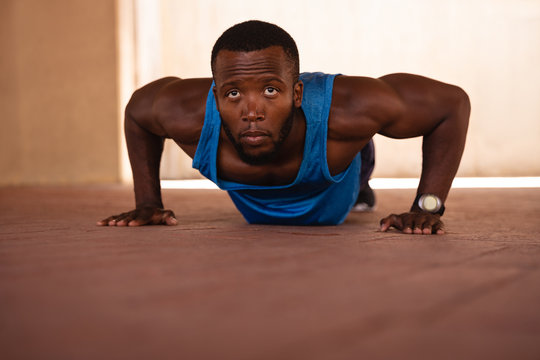 Man doing push-up exercise under the bridge 