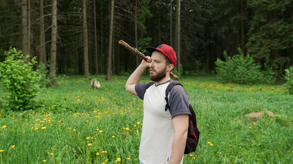 A young guy with a backpack in the cap, traveller in the woods, Hiking, Forest, Journey
