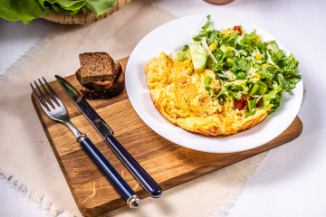Omelet with cheese and salad
