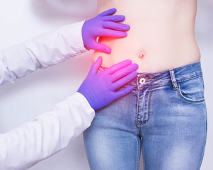 The doctor conducts a visual inspection and palpation of the patient s abdomen on suspicion of...