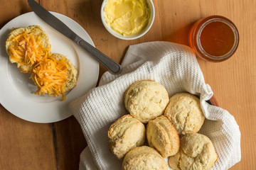 Scones, cheese and butter on wooden kitchen table - Top view photo