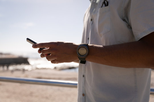 Man using mobile phone at beach 