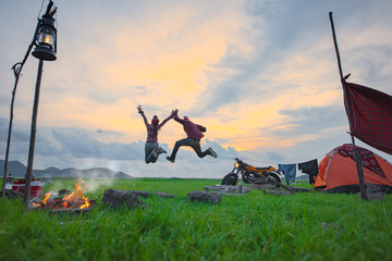 Fototapeta na wymiar couple lover enjoy and cheerfully camping by freedom jumping in the air, countryside trveling of the couple lover, campfire enjoying and relaxing