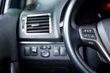 interior of a car, stearing wheel and buttons