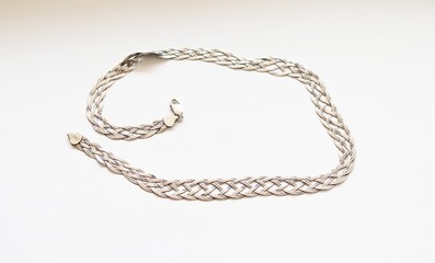 Silver chain located on a white background