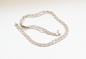 Silver chain located on a white background