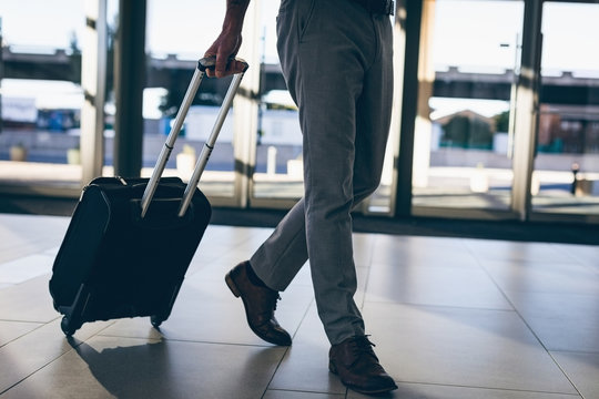 Businessman walking with his travel suitcase