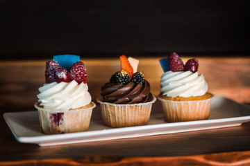 Cupcake with chocolate and butter cream. And also delicious berries.