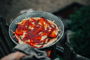 rustic pizza with tomatoes and ketchup on the nature outside  