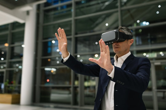 Businessman experiencing VR headset