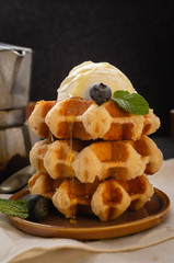 Breakfast with belgian waffles with honey  and blueberries