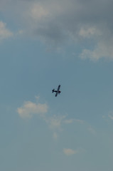 old light aircraft against the sky with clouds