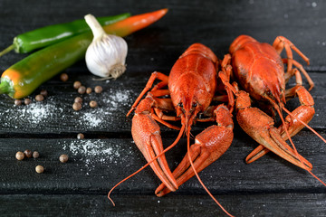 red boiled crayfish with spices on a black background