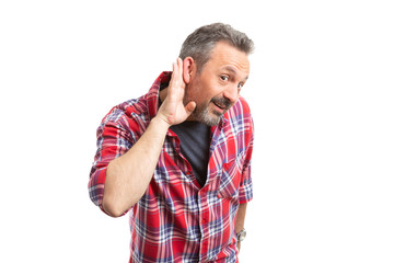 Person eavesdropping with hand near ear