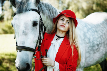 Beautiful young girl with blond hair in a suede jacket with a fringe , wearing black floppy hat