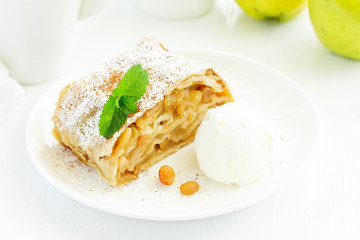 apple strudel with cinnamon and an ice cream ball.