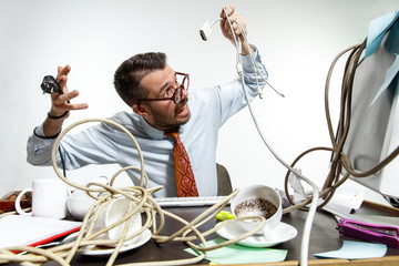 Completely confused. There are a lot of wires in the workplace and man is constantly tangled in...