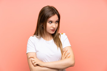 Fototapeta premium Teenager girl over isolated pink wall thinking an idea