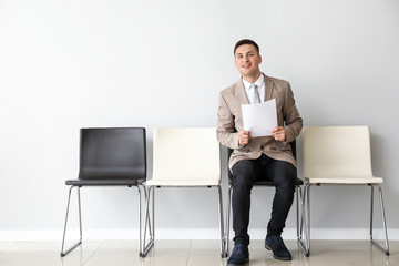 Young man waiting for job interview indoors