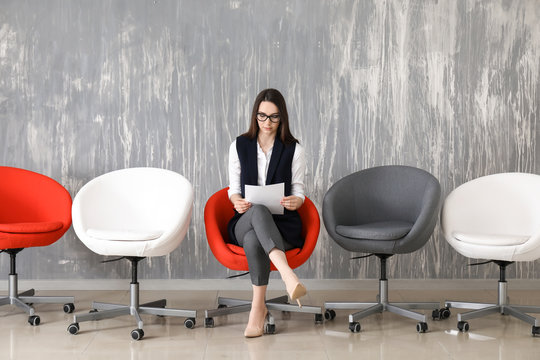 Young woman waiting for job interview indoors