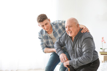 Fototapeta premium Caregiver with senior man in nursing home