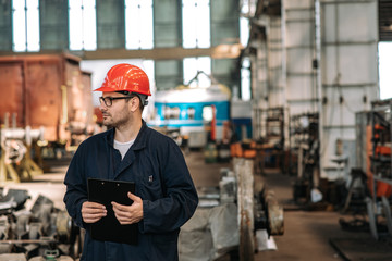 Supervisor at work in heavy industry factory.