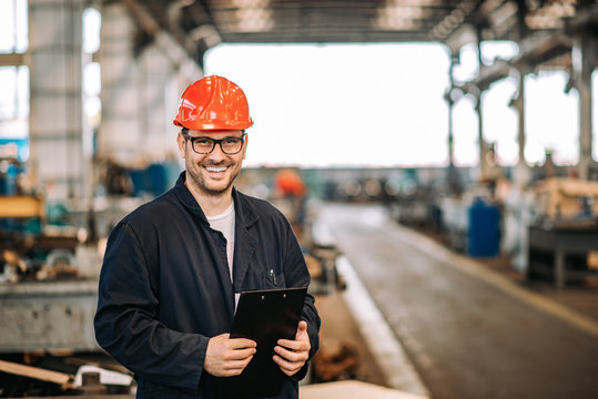 Portrait Of A Smiling Handsome Factory Worker.