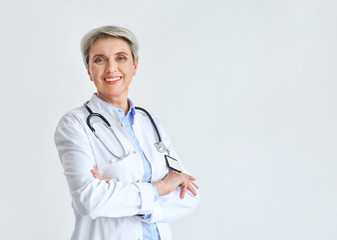 Mature female doctor on light background