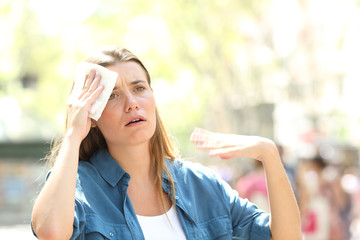 Unhappy woman sweating suffering a heat stroke
