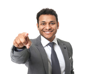 Portrait of handsome businessman pointing at viewer on white background